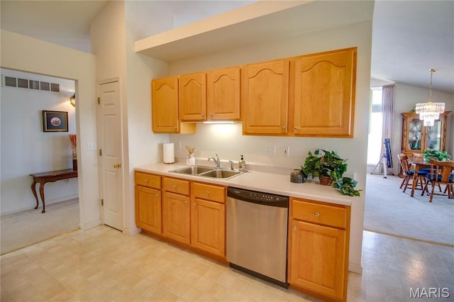 kitchen featuring dishwasher, a sink, light carpet, light countertops, and a chandelier