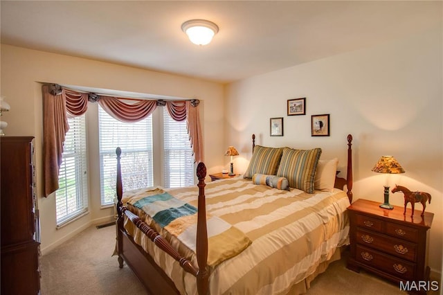 bedroom featuring light colored carpet and baseboards