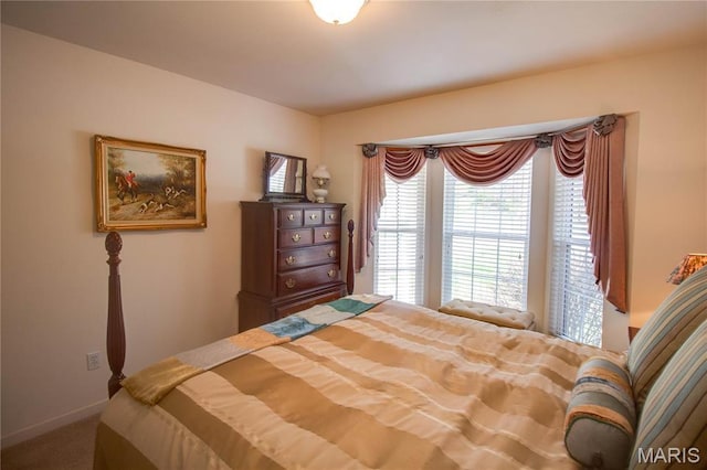 carpeted bedroom featuring baseboards