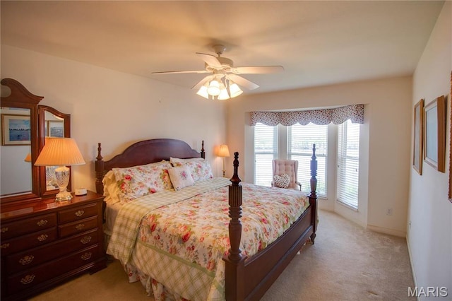 bedroom featuring light colored carpet and a ceiling fan
