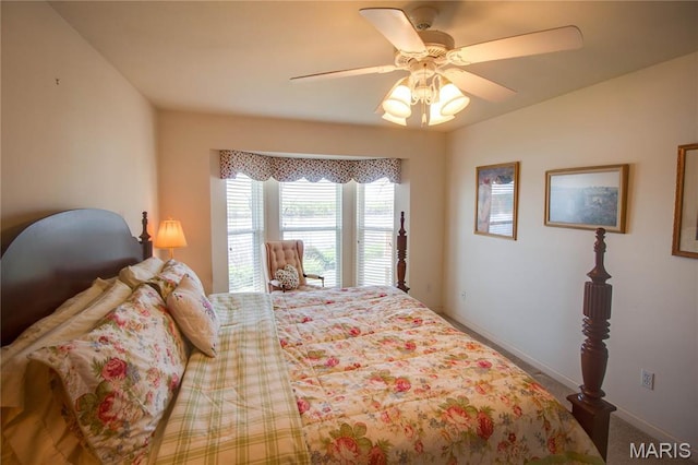 bedroom with a ceiling fan, baseboards, and carpet