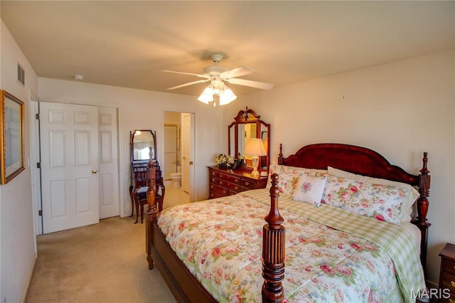 bedroom with light colored carpet and a ceiling fan