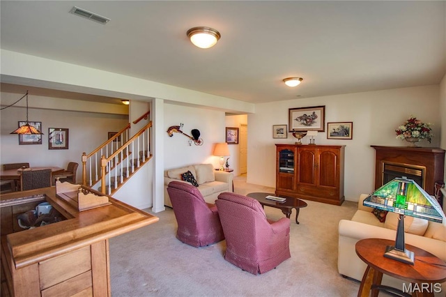 living room with carpet and stairs