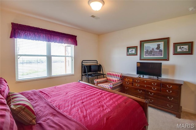 bedroom featuring light colored carpet and baseboards