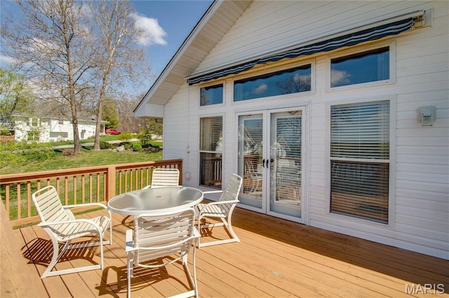 wooden terrace featuring outdoor dining area