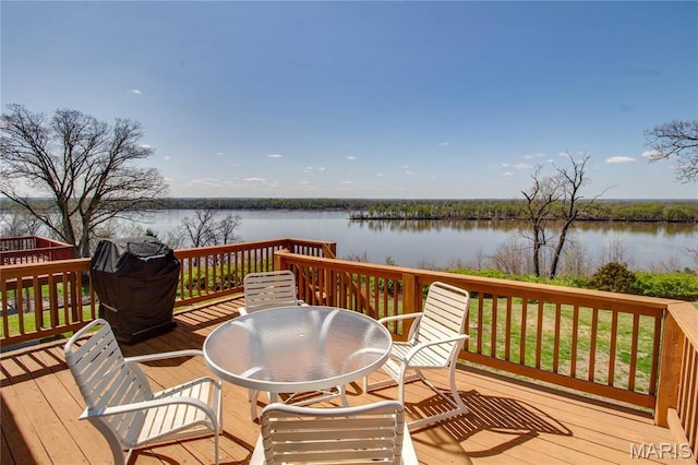 wooden deck featuring a water view and outdoor dining space