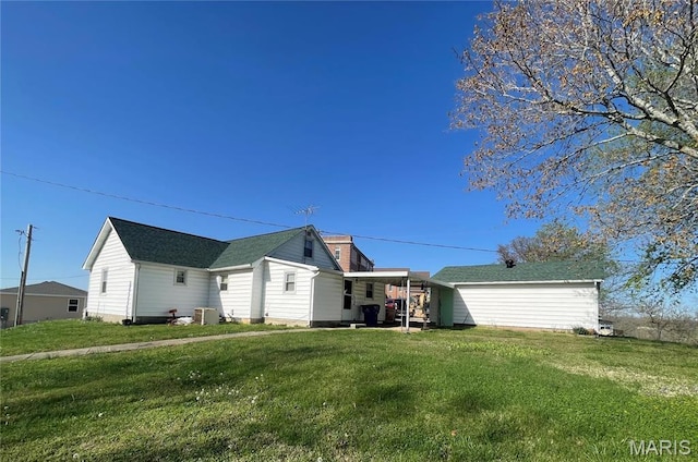 back of house featuring a yard and a chimney