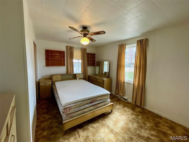 bedroom with dark carpet and ceiling fan