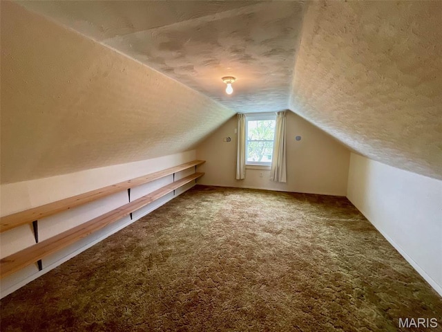 bonus room with a textured ceiling, carpet flooring, and vaulted ceiling
