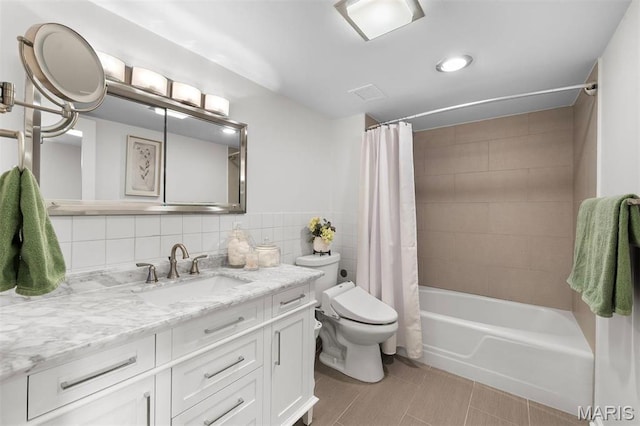 bathroom with toilet, shower / tub combo with curtain, tile walls, and vanity
