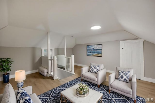 4311 Loughborough Ave, Saint Louis, MO 63116 - living area with wood finished floors, vaulted ceiling, and an upstairs landing