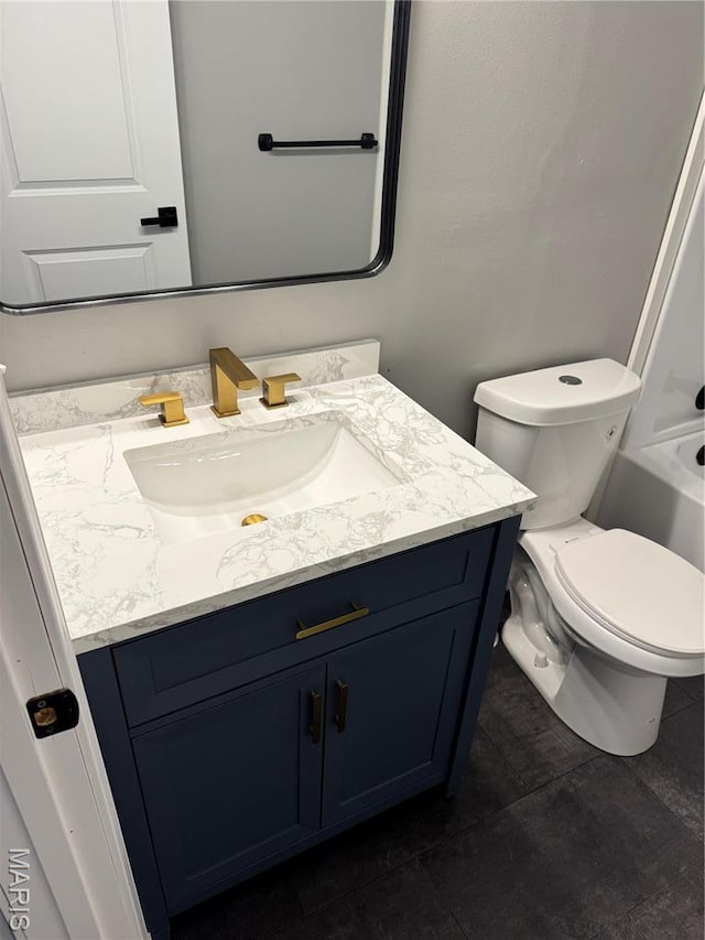 bathroom with vanity, toilet, and tile patterned flooring