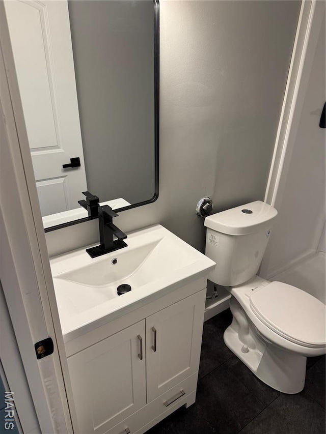 bathroom featuring vanity, toilet, and tile patterned floors