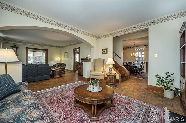 631 N Geyer Rd, Saint Louis, MO 63122 - living area featuring a chandelier, baseboards, arched walkways, stairs, and crown molding