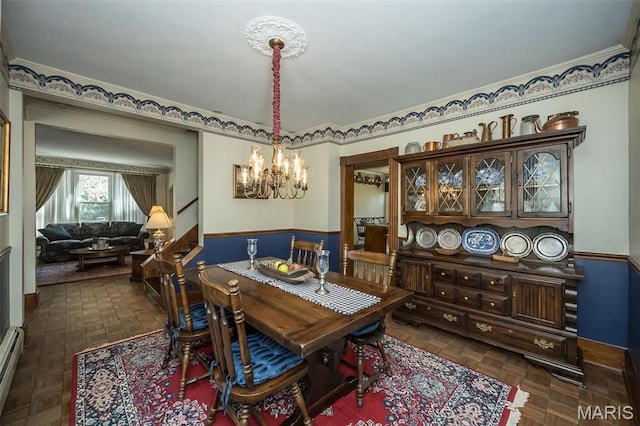 631 N Geyer Rd, Saint Louis, MO 63122 - dining space featuring a chandelier, wainscoting, and a baseboard heating unit