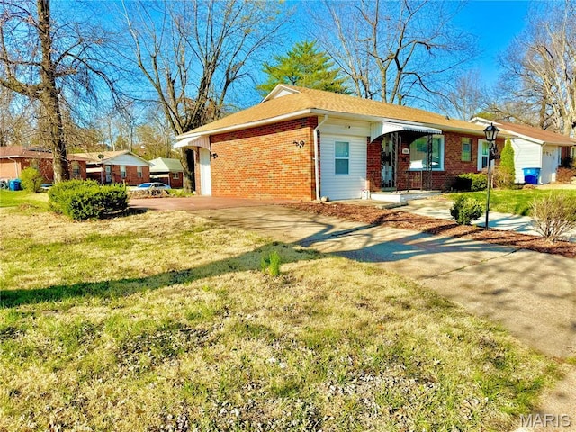 7008 Rohn Dr, Saint Louis, MO 63121 - view of property exterior featuring brick siding, driveway, a yard, and a shingled roof