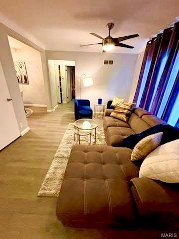 7008 Rohn Dr, Saint Louis, MO 63121 - living area with a ceiling fan, wood finished floors, and baseboards