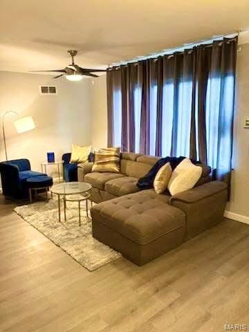 7008 Rohn Dr, Saint Louis, MO 63121 - living area with wood finished floors, ceiling fan, and baseboards