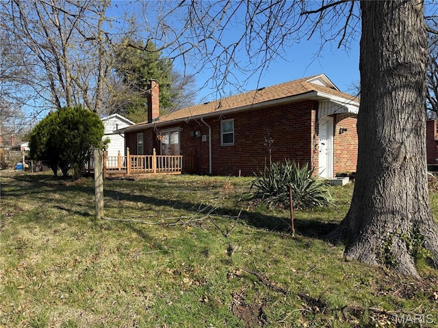 7008 Rohn Dr, Saint Louis, MO 63121 - back of property featuring brick siding, a chimney, a wooden deck, and a yard