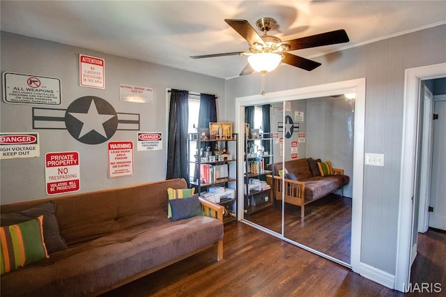 living area with wood finished floors and ceiling fan