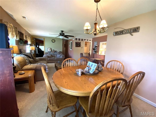 1920 Choctaw Path, Hermann, MO 65041 - dining space featuring light carpet, ceiling fan, a chandelier, and baseboards