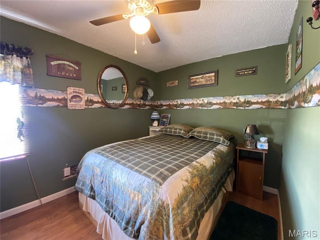 1920 Choctaw Path, Hermann, MO 65041 - bedroom with wood finished floors, baseboards, a textured ceiling, and a ceiling fan