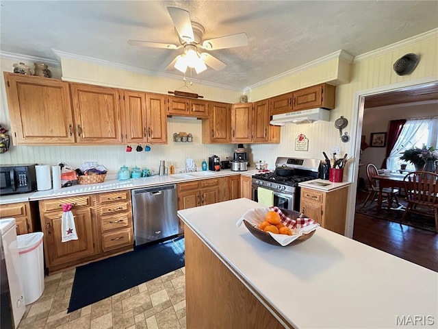 705 E Gibbs St, Salem, MO 65560 - kitchen featuring stainless steel appliances, under cabinet range hood, a sink, light countertops, and crown molding
