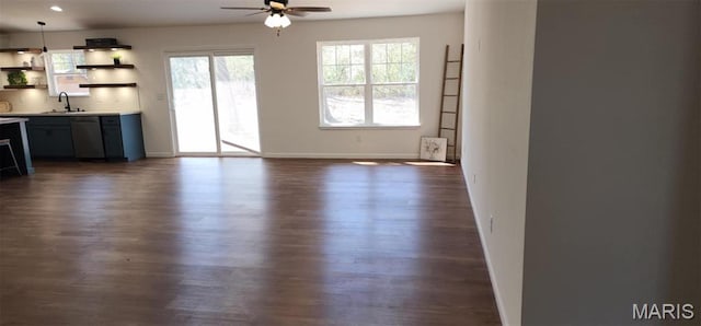 622 Scottsvale Dr, Rolla, MO 65401 - unfurnished dining area featuring dark wood-type flooring, ceiling fan, a sink, and baseboards