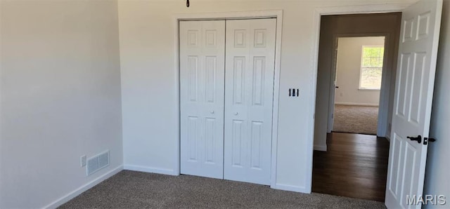 622 Scottsvale Dr, Rolla, MO 65401 - unfurnished bedroom featuring baseboards, dark carpet, and a closet