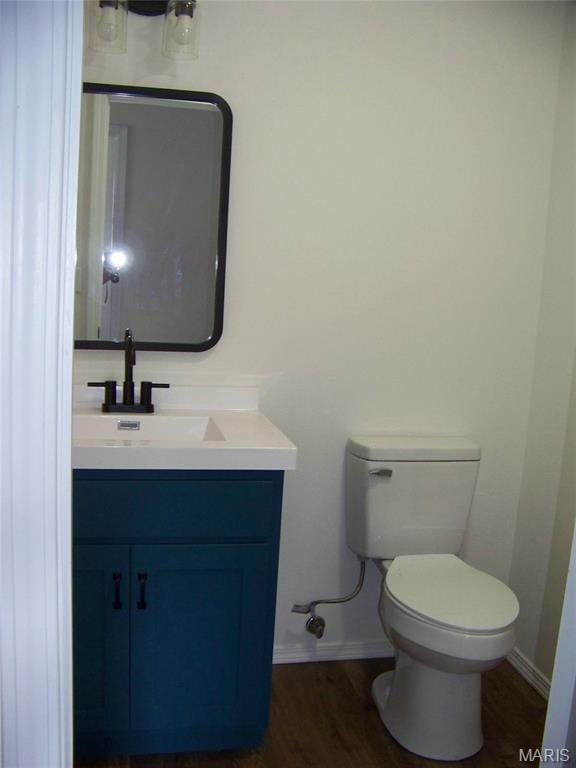 622 Scottsvale Dr, Rolla, MO 65401 - half bath featuring vanity, toilet, baseboards, and wood finished floors