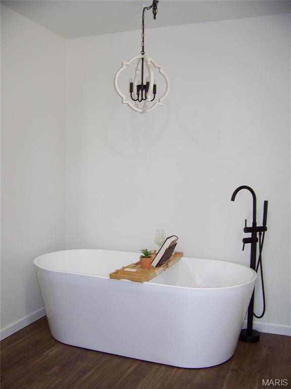 622 Scottsvale Dr, Rolla, MO 65401 - bathroom featuring wood finished floors, baseboards, a chandelier, and a freestanding bath