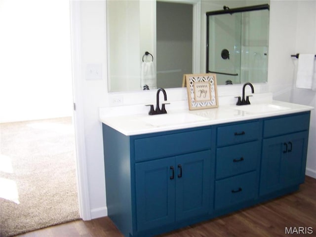 622 Scottsvale Dr, Rolla, MO 65401 - full bathroom featuring double vanity, a shower with door, and wood finished floors