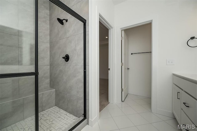 bathroom with a shower stall, vanity, and tile patterned floors