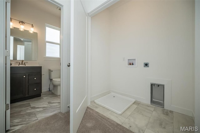 bathroom featuring marble look tile flooring, toilet, vanity, and baseboards