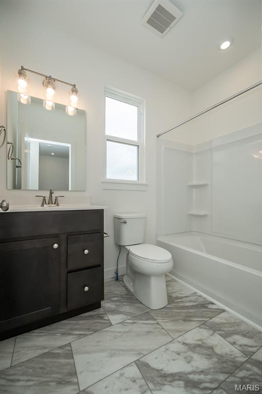 full bath featuring toilet, vanity, shower / bathtub combination, baseboards, and marble finish floors