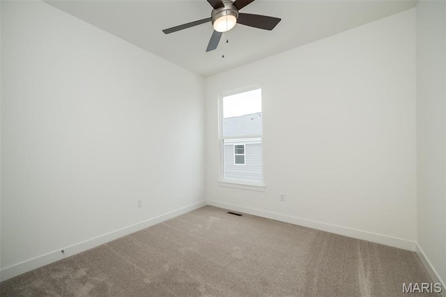 empty room featuring baseboards, carpet, and a ceiling fan