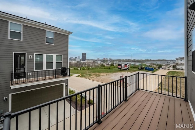 wooden deck with a garage and a city view