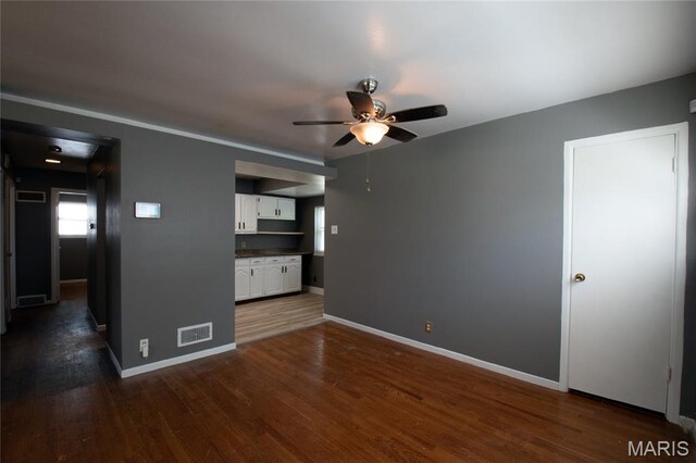 135 Dundee Cir, Saint Louis, MO 63137 - spare room with a ceiling fan, dark wood-type flooring, and baseboards