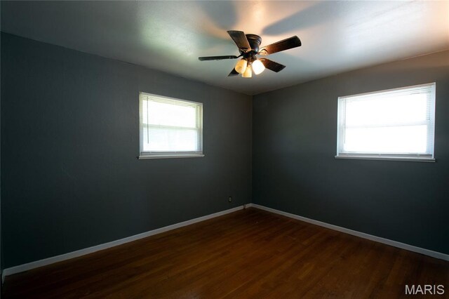 135 Dundee Cir, Saint Louis, MO 63137 - unfurnished room featuring dark wood-style floors, baseboards, and ceiling fan