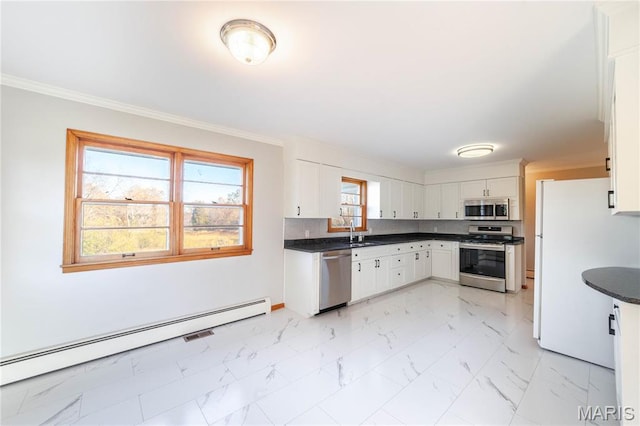 751 E Saint Eunice Rd, Fulton, MO 65251 - kitchen with appliances with stainless steel finishes, a baseboard heating unit, a sink, dark countertops, and white cabinetry