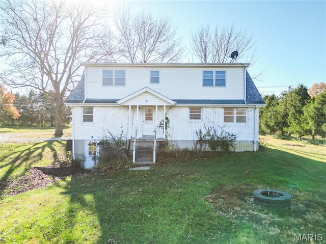 751 E Saint Eunice Rd, Fulton, MO 65251 - traditional home with a front yard, a fire pit, and a shingled roof