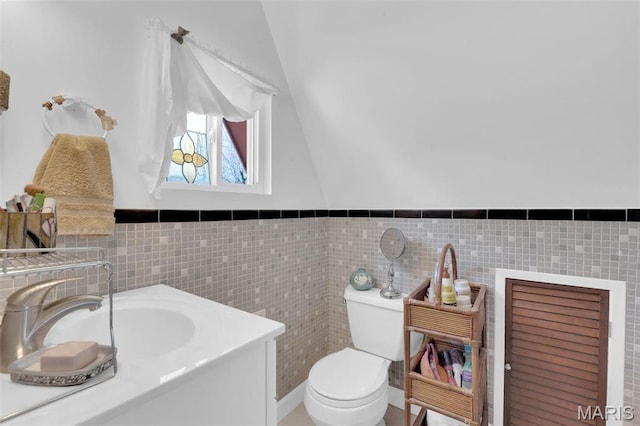 10518 Lakeview Circle Dr, Marthasville, MO 63357 - half bath featuring toilet, a sink, tile walls, a wainscoted wall, and vaulted ceiling
