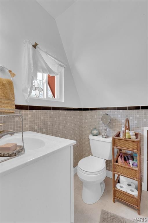 10518 Lakeview Circle Dr, Marthasville, MO 63357 - bathroom with toilet, vaulted ceiling, tile walls, and a wainscoted wall