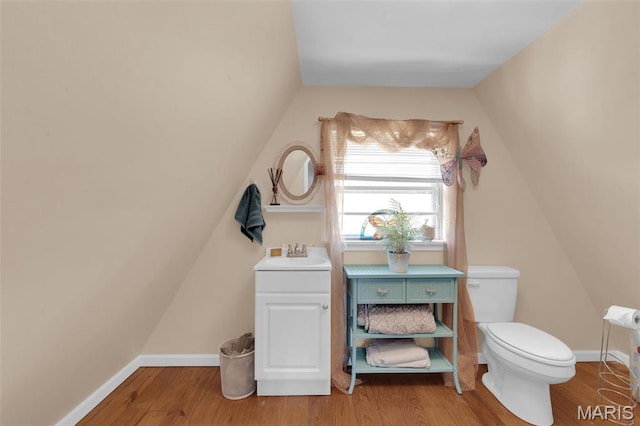 10518 Lakeview Circle Dr, Marthasville, MO 63357 - half bathroom with a sink, wood finished floors, toilet, vaulted ceiling, and baseboards