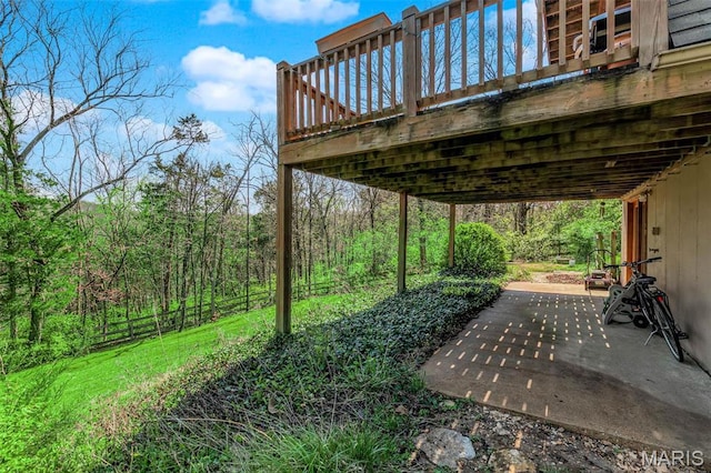 10518 Lakeview Circle Dr, Marthasville, MO 63357 - view of yard featuring a patio, a wooden deck, a forest view, and fence