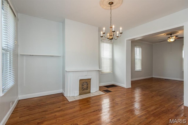 4340 Arsenal St, Saint Louis, MO 63116 - unfurnished living room featuring wood finished floors, a chandelier, baseboards, and ceiling fan