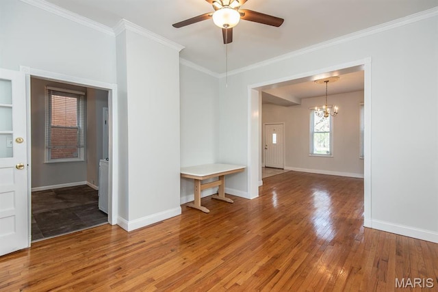 4340 Arsenal St, Saint Louis, MO 63116 - empty room featuring light wood-style flooring, a chandelier, ceiling fan, crown molding, and baseboards