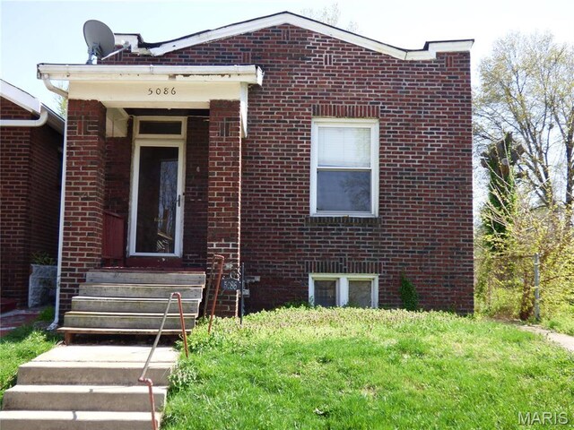 5086 Arlington Ave, Saint Louis, MO 63120 - view of front of home with brick siding and a front lawn