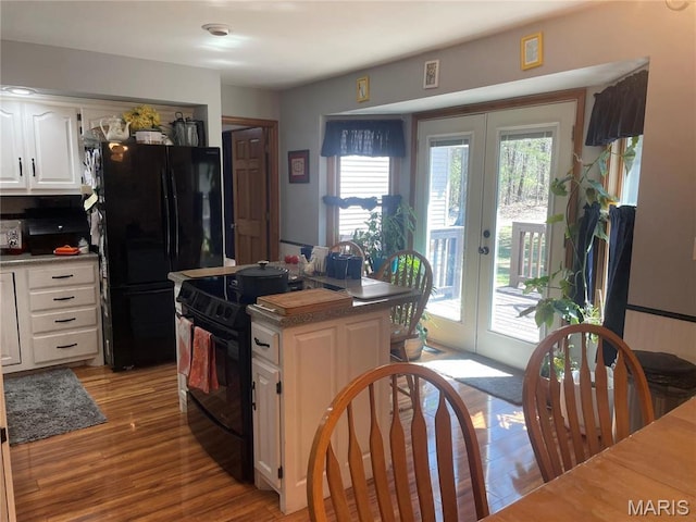 4101 Juedeman Rd, Mo, MO 65453 - kitchen with black appliances, french doors, plenty of natural light, and white cabinetry