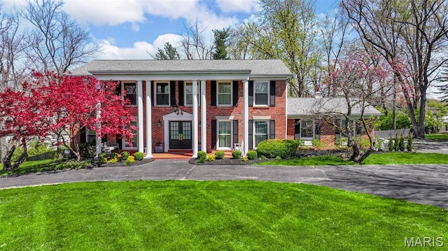 1304 Brynnwood Dr, Saint Louis, MO 63124 - greek revival inspired property featuring brick siding, a front lawn, and french doors